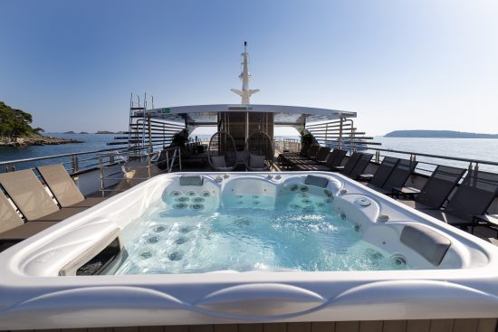 MS Desire sun deck with jacuzzi and ample deck chairs.