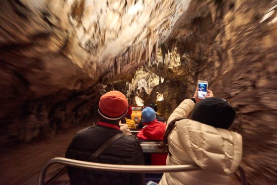 Go for an underground  train ride through Postojna Caves fascinating setting.