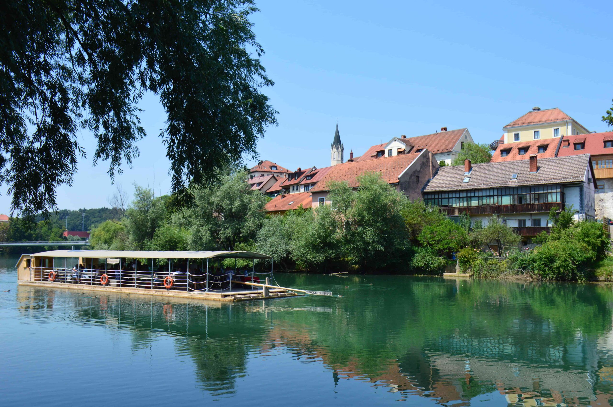 A tranquil sailing on board a traditional raft on the Krka River near Novo Mesto